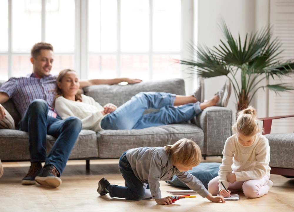 A happy family all sitting around a table